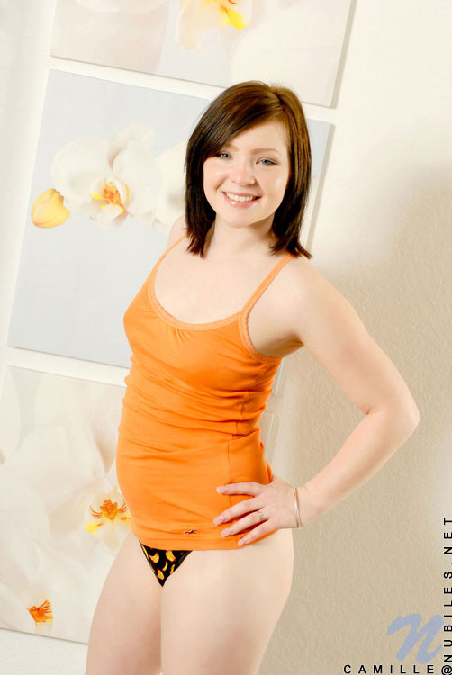 Seductive teen shows her pussy with a black thongs while standing on the wall